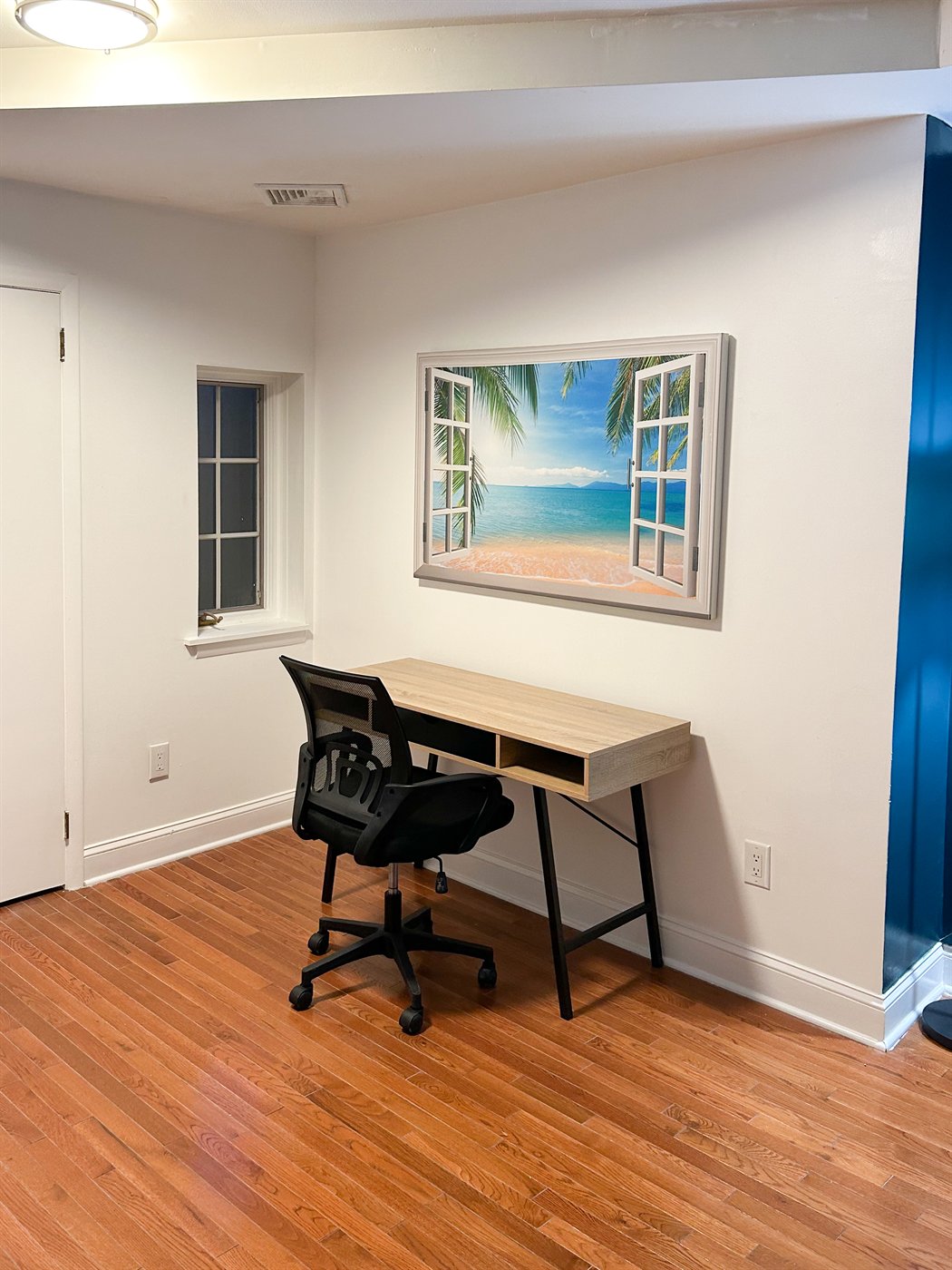 Desk and office chair beside a window