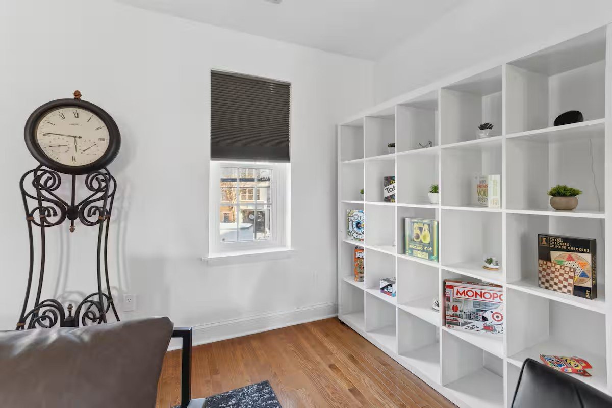 Game station with board games on a white shelf