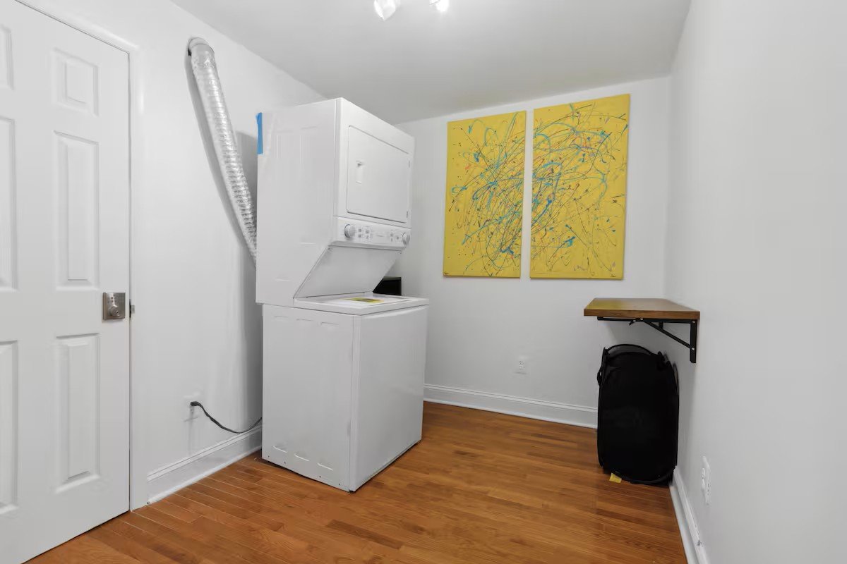Laundry room with stacked washer and dryer